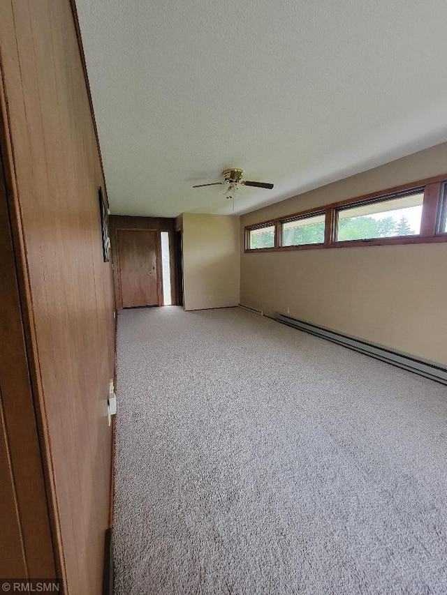 109 Jackson St W, Eagle Bend, MN 56446 - carpeted empty room featuring a baseboard heating unit and a ceiling fan