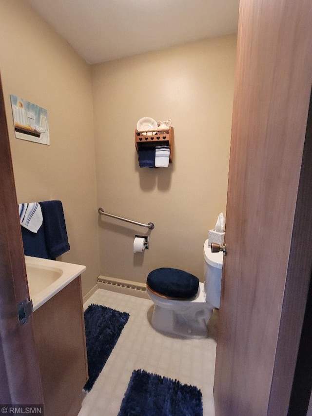 109 Jackson St W, Eagle Bend, MN 56446 - half bathroom with toilet, baseboards, vanity, and a baseboard heating unit