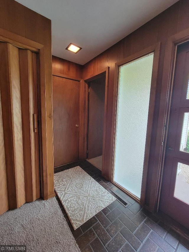 109 Jackson St W, Eagle Bend, MN 56446 - entrance foyer with brick patterned flooring and wood walls