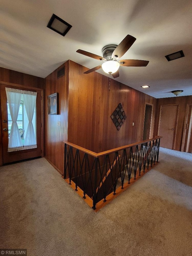 109 Jackson St W, Eagle Bend, MN 56446 - staircase featuring wooden walls, carpet flooring, and a ceiling fan