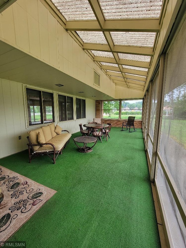 109 Jackson St W, Eagle Bend, MN 56446 - sunroom featuring carpet floors, wood walls, and outdoor lounge area