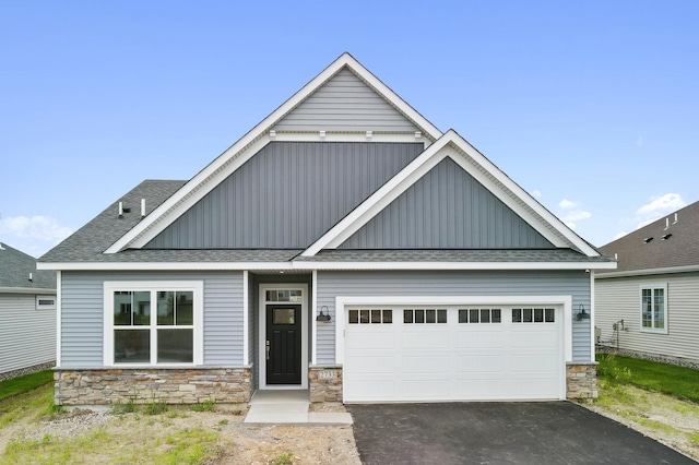 2733 Kama Ave NE, Saint Michael, MN 55376 - craftsman inspired home featuring board and batten siding, stone siding, a shingled roof, and asphalt driveway