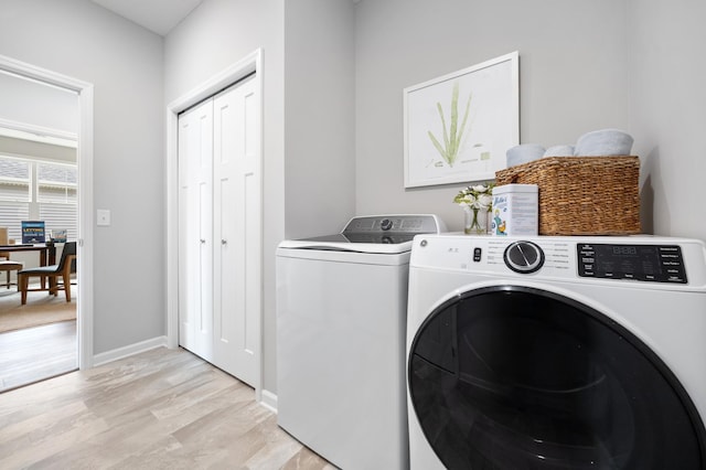2733 Kama Ave NE, Saint Michael, MN 55376 - laundry area featuring washer and dryer, light wood-type flooring, baseboards, and a desk