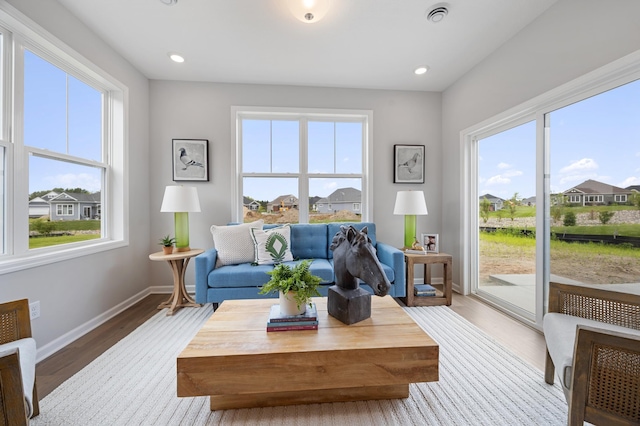 2733 Kama Ave NE, Saint Michael, MN 55376 - living room with wood finished floors, baseboards, recessed lighting, and a residential view