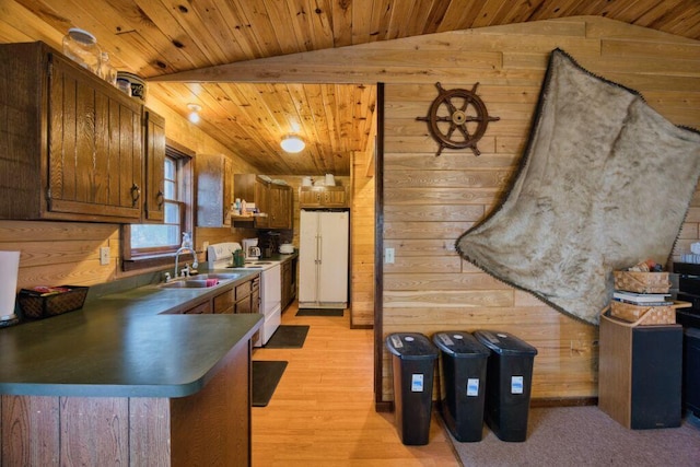 30901 Sunny Beach Rd, Grand Rapids, MN 55744 - kitchen with white appliances, a sink, wood walls, vaulted ceiling, and dark countertops
