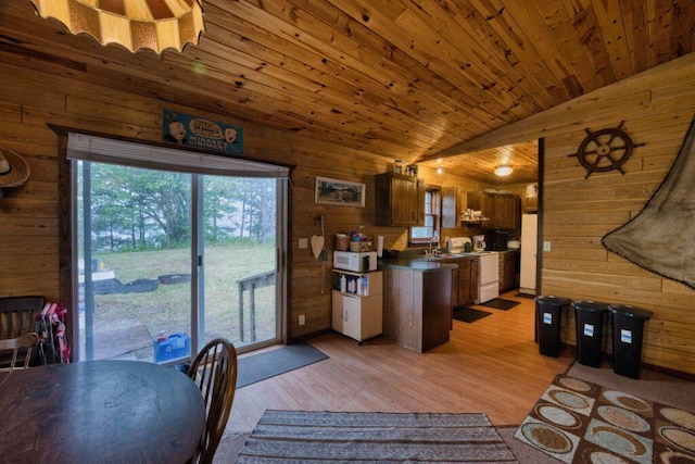 30901 Sunny Beach Rd, Grand Rapids, MN 55744 - kitchen featuring white microwave, wooden walls, lofted ceiling, light wood finished floors, and wood ceiling