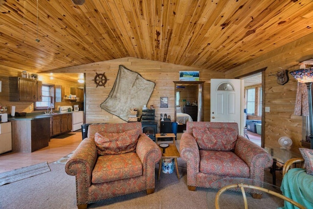 30901 Sunny Beach Rd, Grand Rapids, MN 55744 - living area with wood walls, vaulted ceiling, healthy amount of natural light, light wood-style flooring, and wooden ceiling
