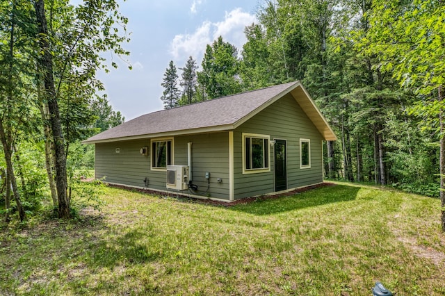 15989 Lost Oaks Dr SE, Cass Lake, MN 56633 - view of home's exterior featuring a cooling unit, a lawn, and a shingled roof