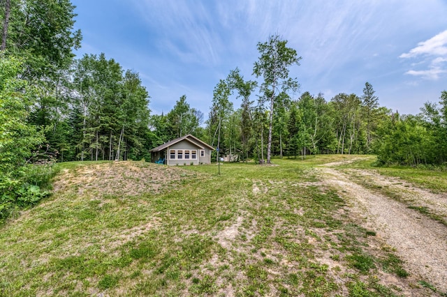 15989 Lost Oaks Dr SE, Cass Lake, MN 56633 - view of grassy yard featuring a wooded view