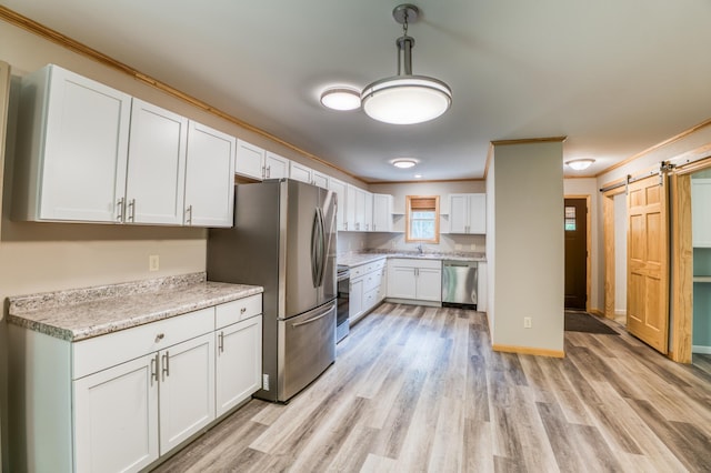 15989 Lost Oaks Dr SE, Cass Lake, MN 56633 - kitchen with stainless steel appliances, light wood-style flooring, white cabinets, a barn door, and ornamental molding