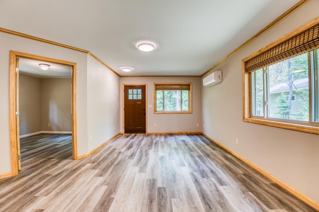 15989 Lost Oaks Dr SE, Cass Lake, MN 56633 - entryway with ornamental molding, light wood finished floors, a wall mounted AC, and baseboards
