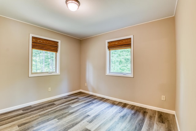 15989 Lost Oaks Dr SE, Cass Lake, MN 56633 - unfurnished room with wood finished floors, baseboards, and ornamental molding