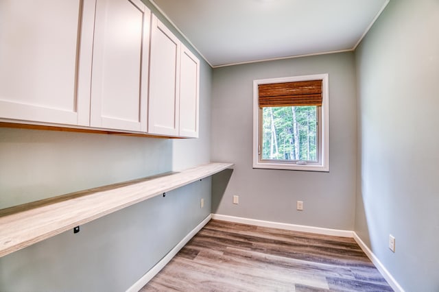 15989 Lost Oaks Dr SE, Cass Lake, MN 56633 - unfurnished office with wood finished floors, built in study area, and baseboards