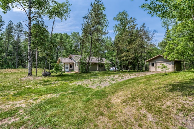 15989 Lost Oaks Dr SE, Cass Lake, MN 56633 - view of green lawn with a garage and an outdoor structure