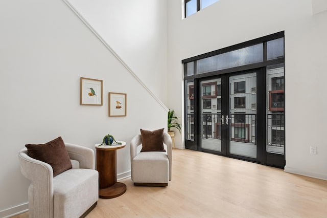 3104 Lake St Unit 412, Minneapolis, MN 55416 - living area with wood finished floors, baseboards, and a towering ceiling