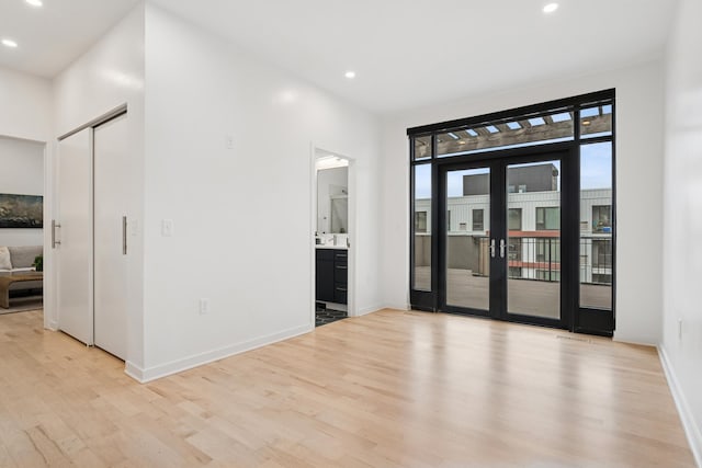 3104 Lake St Unit 412, Minneapolis, MN 55416 - empty room with light wood-style floors, recessed lighting, baseboards, and french doors
