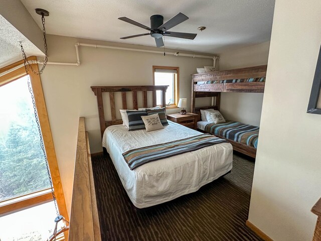 122 Bridge Run Ln Unit A, Lutsen Twp, MN 55615 - bedroom featuring baseboards, a ceiling fan, and carpet