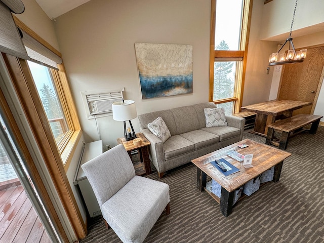 122 Bridge Run Ln Unit A, Lutsen Twp, MN 55615 - living area with plenty of natural light, a chandelier, a high ceiling, and a wall unit AC