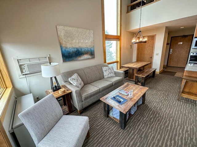 122 Bridge Run Ln Unit A, Lutsen Twp, MN 55615 - living room with a chandelier, a high ceiling, and a wall mounted air conditioner