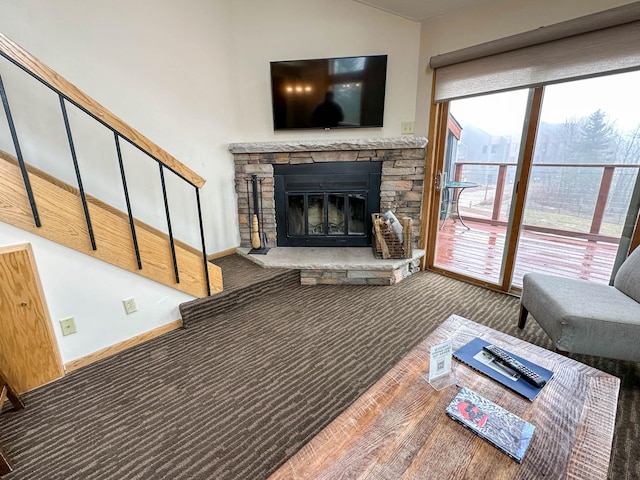 122 Bridge Run Ln Unit A, Lutsen Twp, MN 55615 - living room with carpet floors, a fireplace, lofted ceiling, baseboards, and stairway