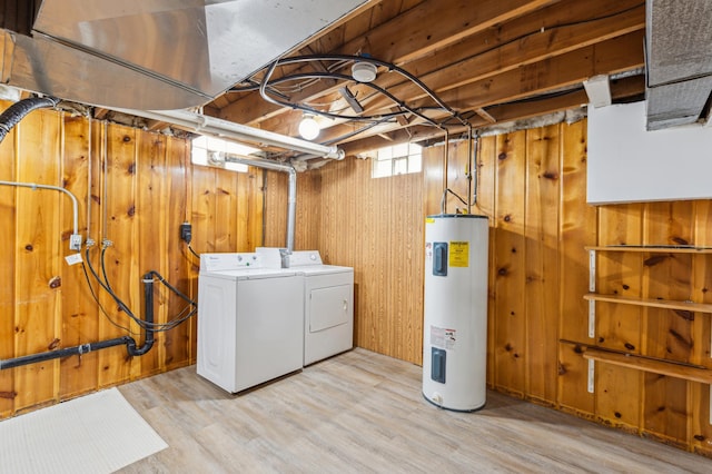 348 6th Ave S, Saint Cloud, MN 56301 - below grade area featuring electric water heater, washer and dryer, wood walls, and light wood-style floors