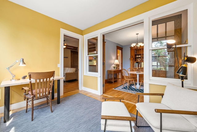 1112 25th St Unit 203, Minneapolis, MN 55405 - home office featuring a chandelier, wood finished floors, and baseboards