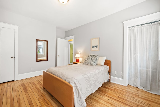 1112 25th St Unit 203, Minneapolis, MN 55405 - bedroom featuring light wood-style flooring and baseboards