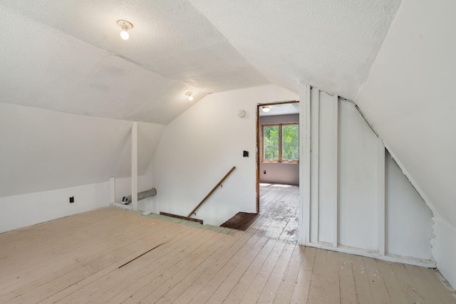 7627 Main St, Danbury, WI 54830 - bonus room with a textured ceiling, hardwood / wood-style floors, and lofted ceiling