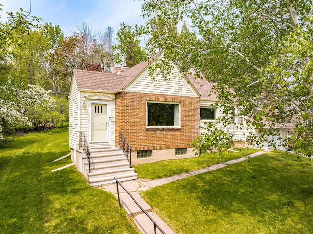 3319 Superior St, Duluth, MN 55804 - view of front facade with a front yard, a shingled roof, brick siding, and entry steps