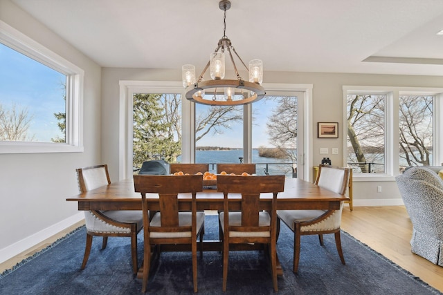 3100 Island View Dr, Mound, MN 55364 - dining area with a chandelier, wood finished floors, baseboards, and a water view