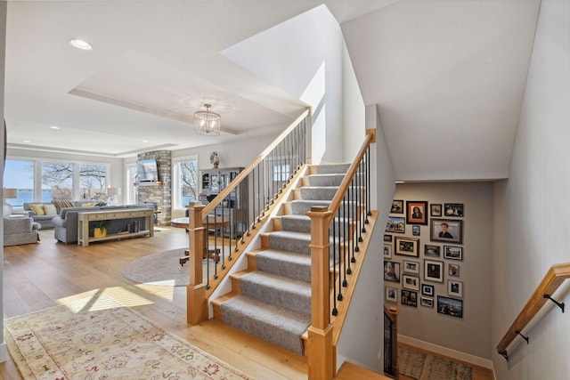 3100 Island View Dr, Mound, MN 55364 - staircase featuring hardwood / wood-style flooring, recessed lighting, baseboards, and a chandelier