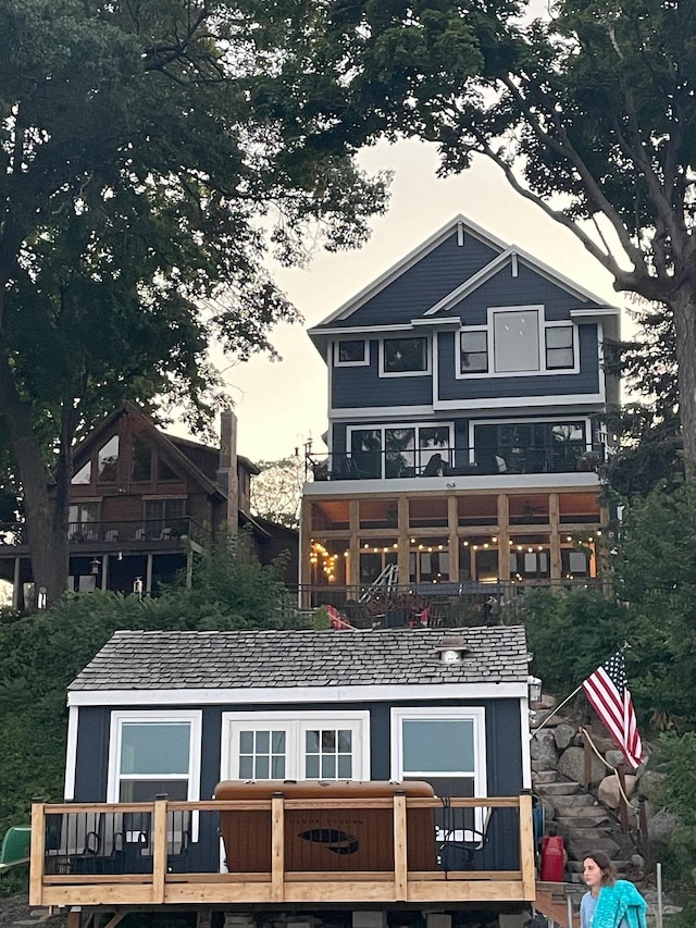 3100 Island View Dr, Mound, MN 55364 - back of house at dusk with a wooden deck
