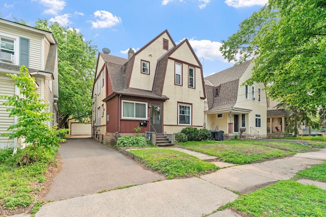 662 24th Ave NE, Minneapolis, MN 55418 - dutch colonial featuring roof with shingles, a gambrel roof, an outdoor structure, and a detached garage