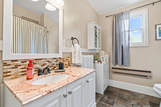 662 24th Ave NE, Minneapolis, MN 55418 - bathroom with a baseboard radiator, tasteful backsplash, vanity, baseboards, and toilet