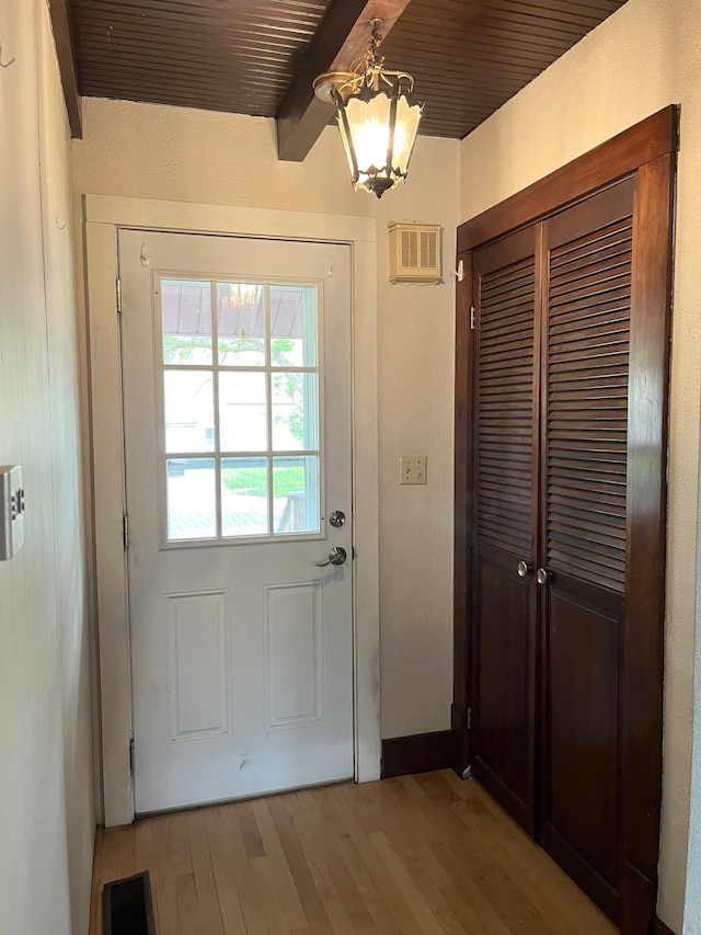 845 12th St, Windom, MN 56101 - entryway with beam ceiling, light wood finished floors, a chandelier, and baseboards