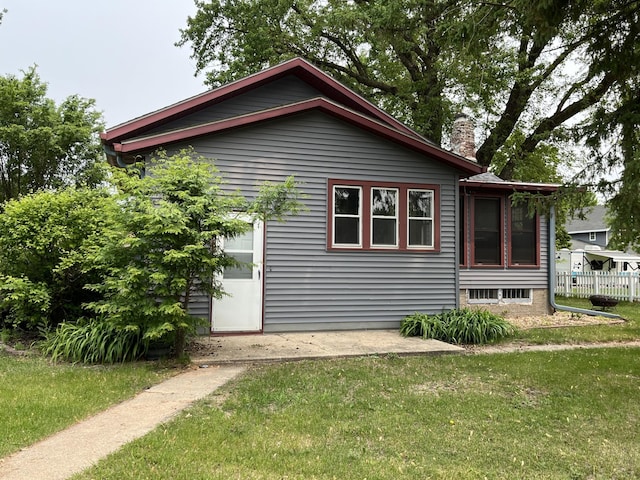 845 12th St, Windom, MN 56101 - view of side of property with a chimney and a patio