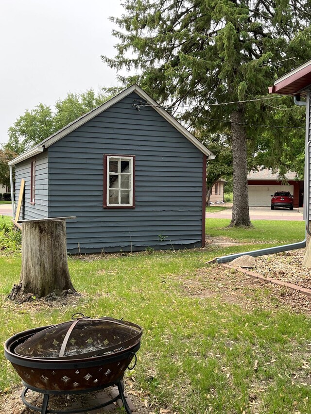 845 12th St, Windom, MN 56101 - view of property exterior featuring an outdoor fire pit and a lawn