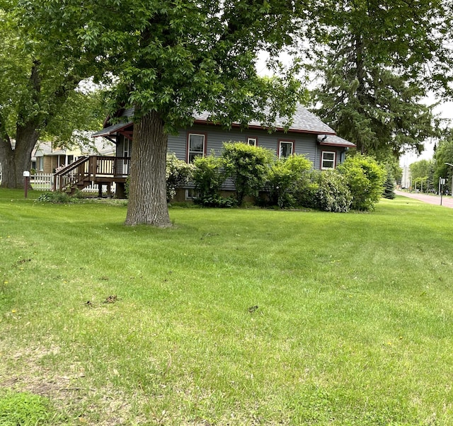 845 12th St, Windom, MN 56101 - view of green lawn with a wooden deck and stairway