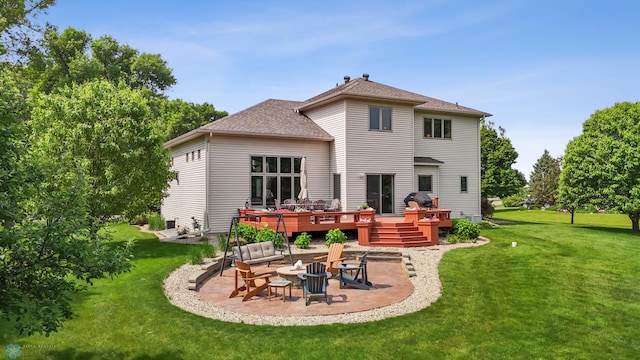 117 50th Ave E, Fargo, ND 58078 - back of house featuring a patio, a wooden deck, a lawn, and roof with shingles