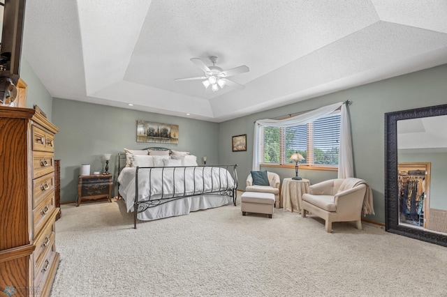 117 50th Ave E, West Fargo, ND 58078 - bedroom featuring carpet floors, a raised ceiling, and a ceiling fan