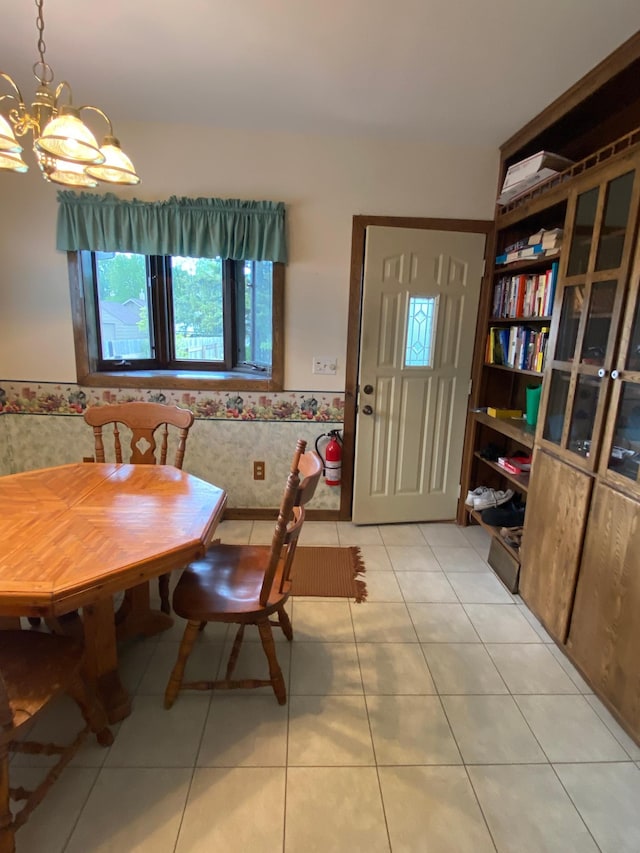 1004 9th St 1006, International Falls, MN 56649 - dining area with a chandelier, light tile patterned floors, and a wainscoted wall