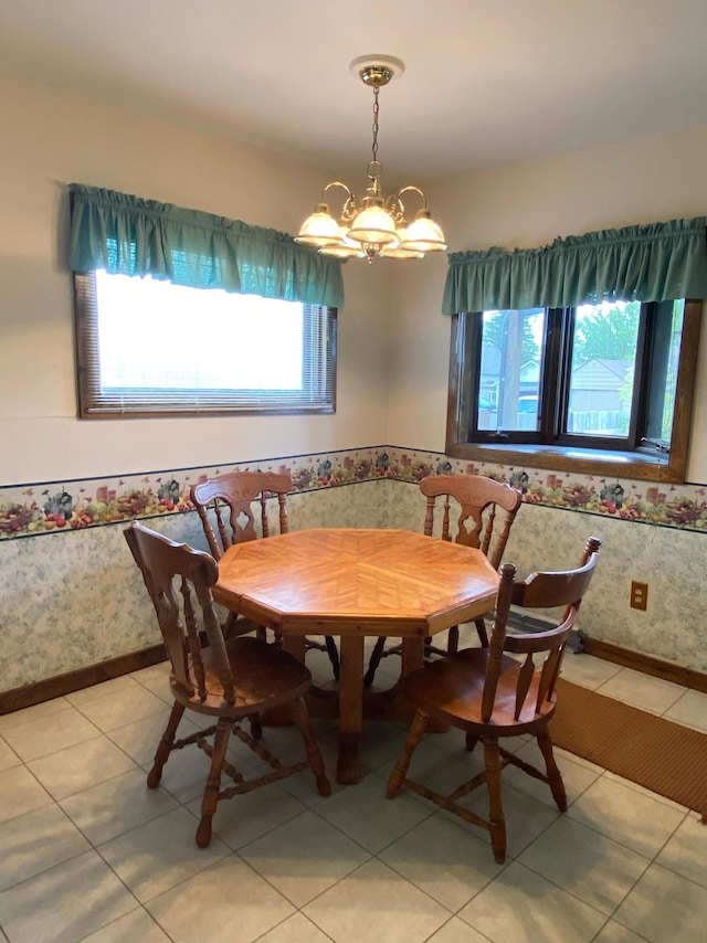1004 9th St 1006, International Falls, MN 56649 - dining area featuring breakfast area, a chandelier, light tile patterned floors, and baseboards