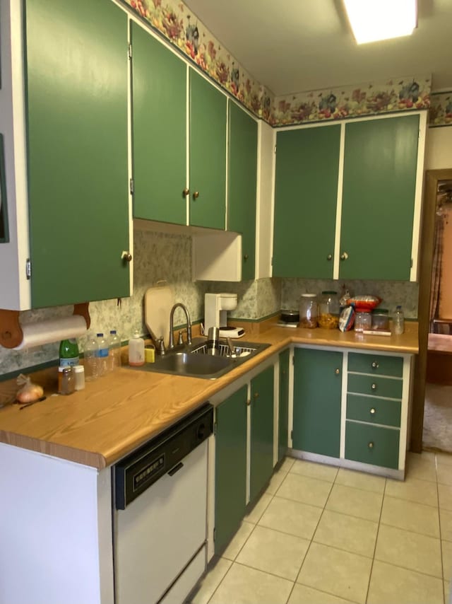 1004 9th St 1006, International Falls, MN 56649 - kitchen with white dishwasher, a sink, light tile patterned floors, and backsplash