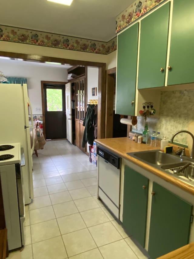 1004 9th St 1006, International Falls, MN 56649 - kitchen with green cabinetry, white appliances, a sink, and light tile patterned floors