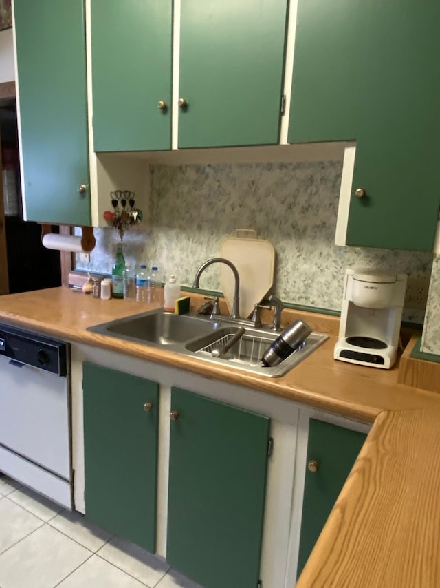 1004 9th St 1006, International Falls, MN 56649 - kitchen featuring dishwasher, light countertops, light tile patterned floors, a sink, and green cabinetry