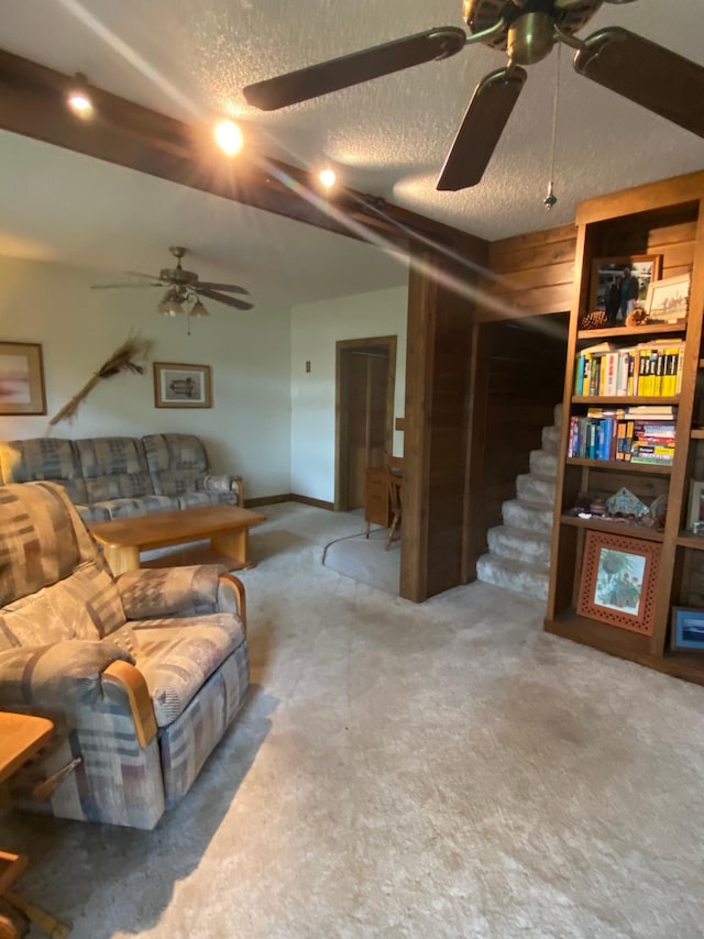 1004 9th St 1006, International Falls, MN 56649 - living room featuring a ceiling fan, carpet, a textured ceiling, and stairs