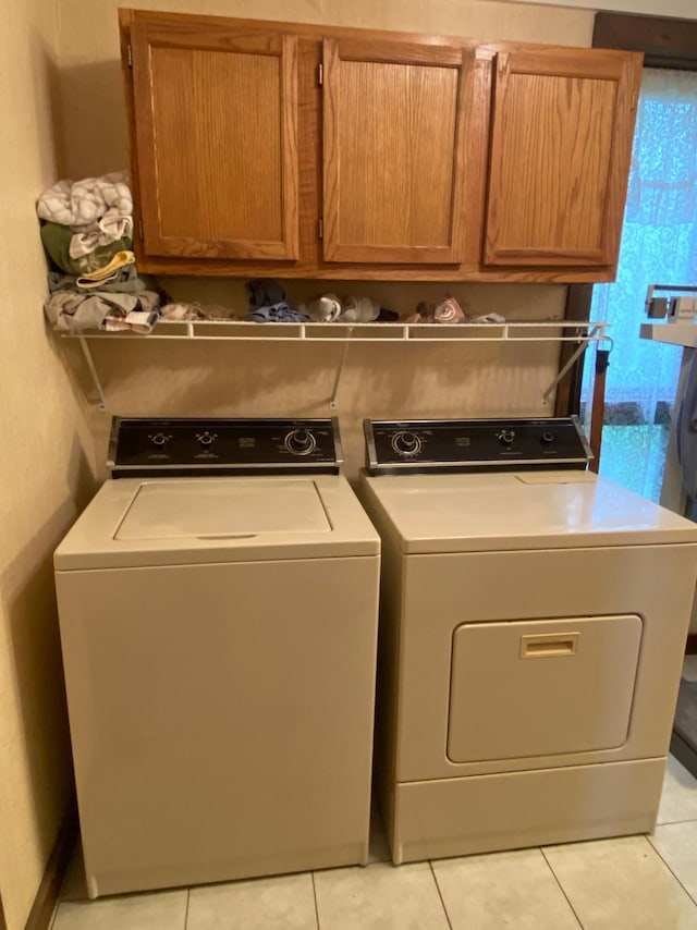 1004 9th St 1006, International Falls, MN 56649 - washroom with cabinet space, separate washer and dryer, and light tile patterned floors