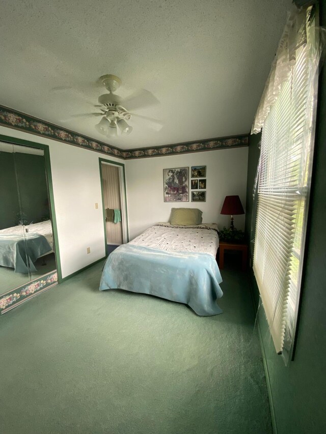 1004 9th St 1006, International Falls, MN 56649 - bedroom with carpet flooring, ceiling fan, and a textured ceiling