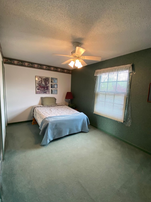 1004 9th St 1006, International Falls, MN 56649 - carpeted bedroom featuring a textured ceiling and ceiling fan
