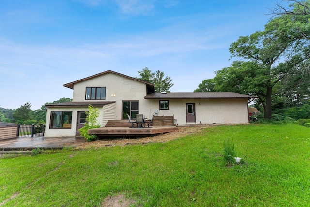 7567 Lent Trl, Lent Twp, MN 55079 - rear view of house with stucco siding, a wooden deck, and a lawn
